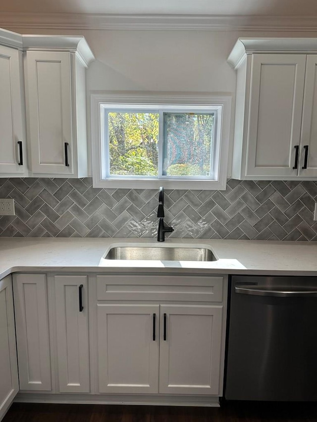 kitchen with white cabinetry, sink, and stainless steel dishwasher