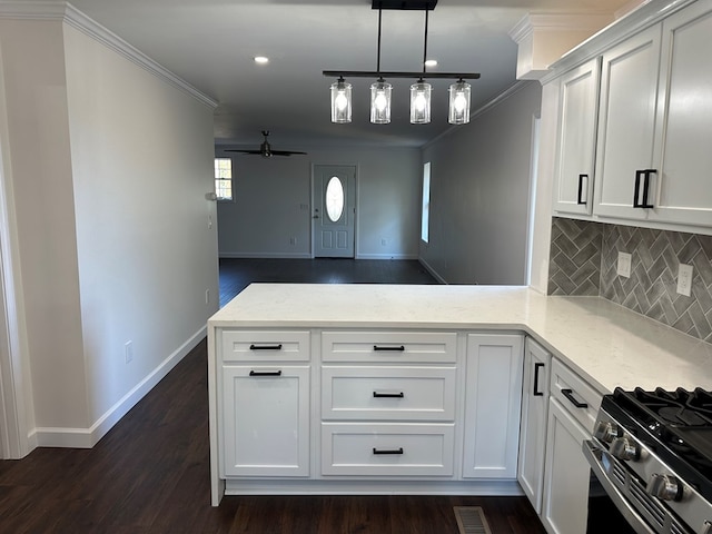 kitchen with white cabinetry, kitchen peninsula, ceiling fan, and stainless steel gas stove