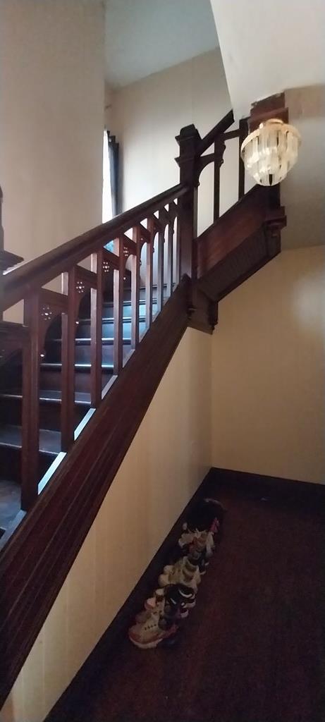 stairs with a chandelier