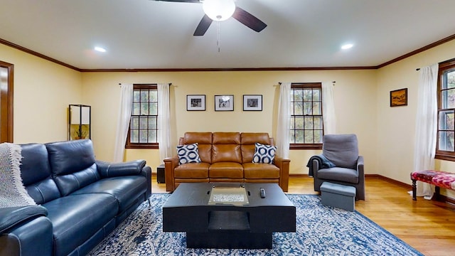 living room featuring hardwood / wood-style flooring, plenty of natural light, ornamental molding, and ceiling fan