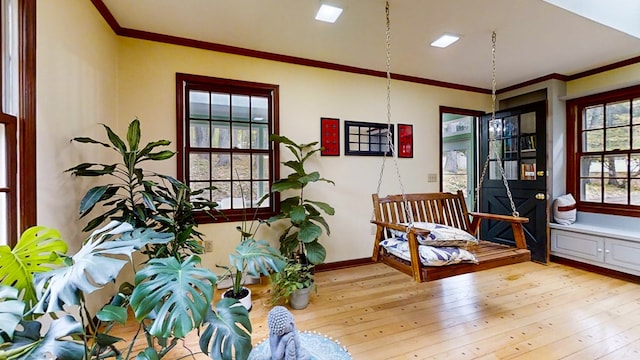 living area featuring light hardwood / wood-style floors and ornamental molding