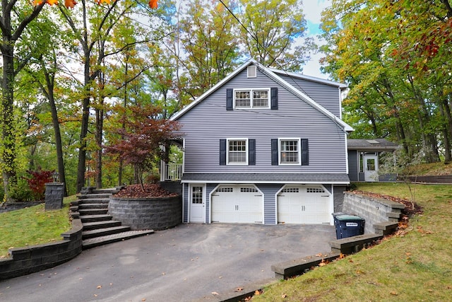 view of home's exterior with a garage and a lawn