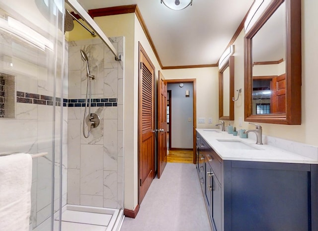 bathroom with crown molding, vanity, and an enclosed shower