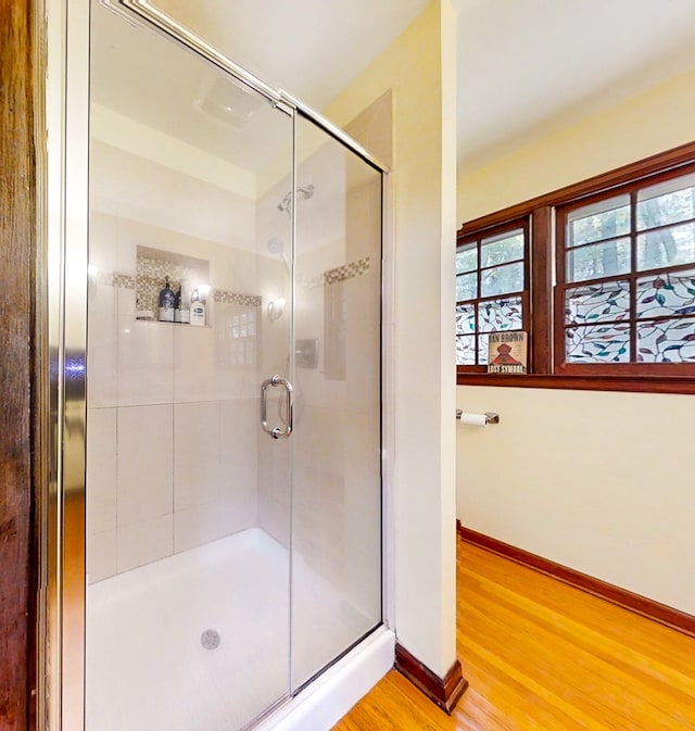 bathroom with hardwood / wood-style floors and walk in shower