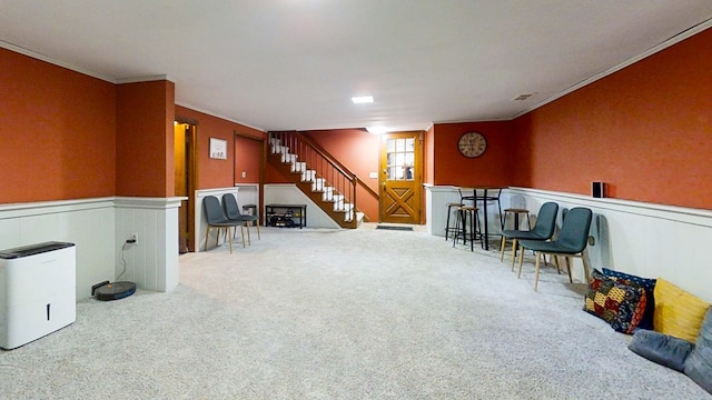 sitting room with carpet floors and ornamental molding