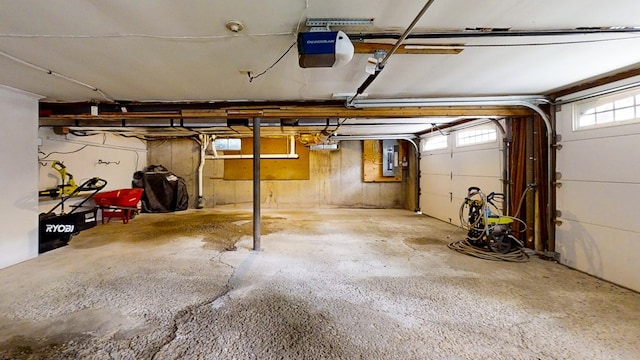 garage featuring electric panel and a garage door opener