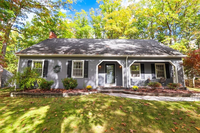 view of front of property with a porch and a front lawn