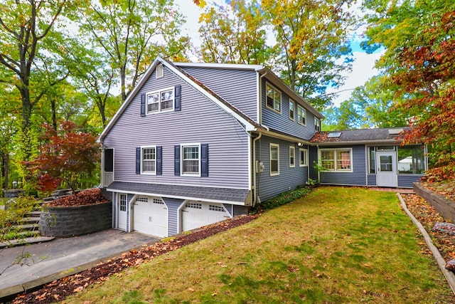 view of side of property featuring a yard and a garage