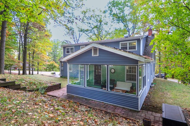 back of house featuring a sunroom