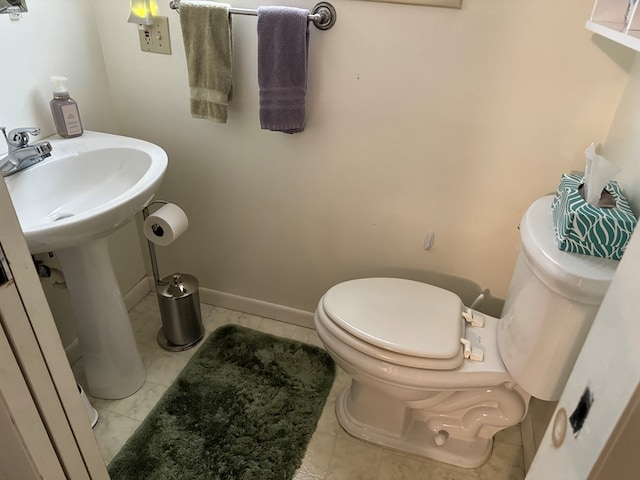 bathroom with tile patterned floors and toilet