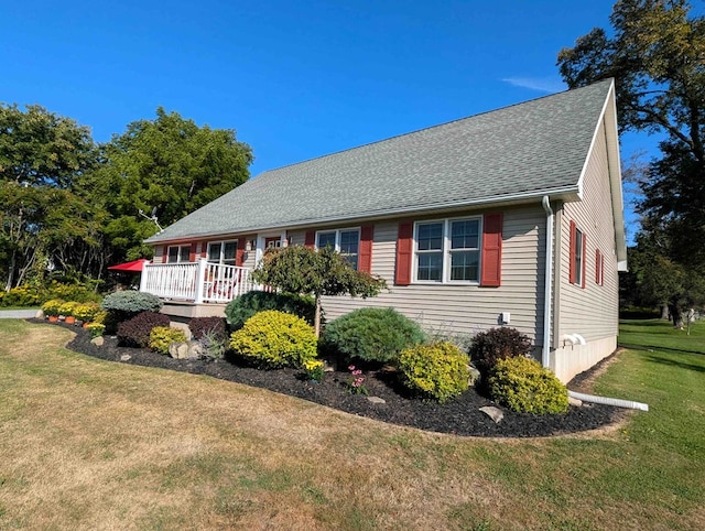 view of property exterior featuring a wooden deck and a yard