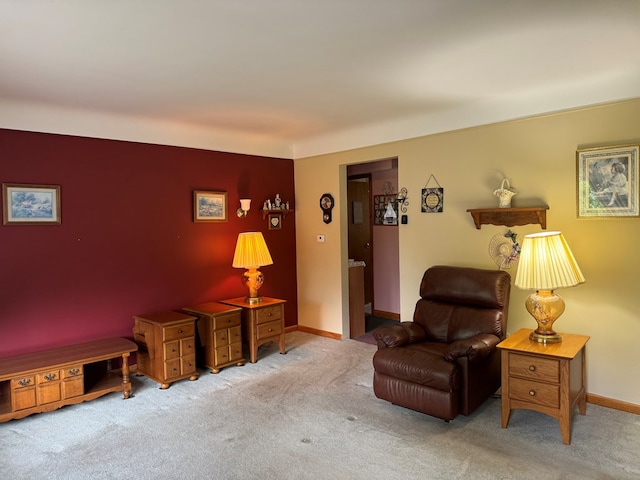 sitting room featuring light colored carpet