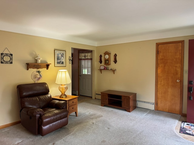 sitting room with light colored carpet and a baseboard heating unit