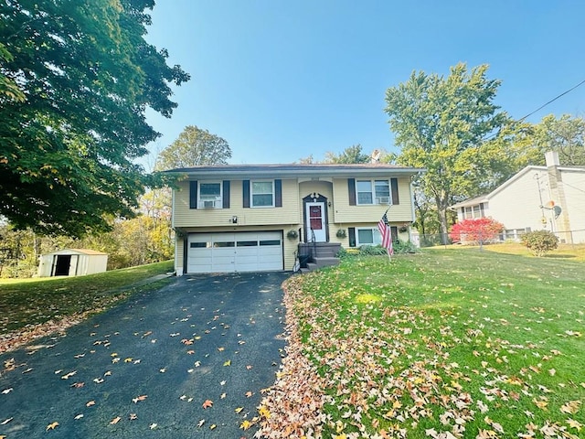 bi-level home with a storage shed, a front yard, and a garage