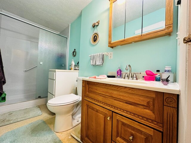 bathroom featuring vanity, a textured ceiling, toilet, and a shower with shower door