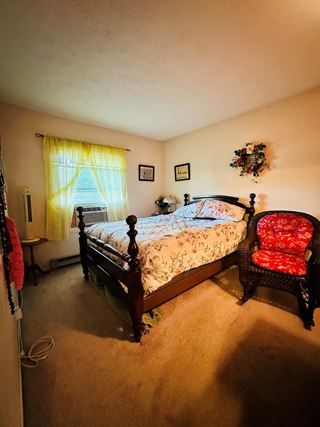 carpeted bedroom with baseboard heating and cooling unit