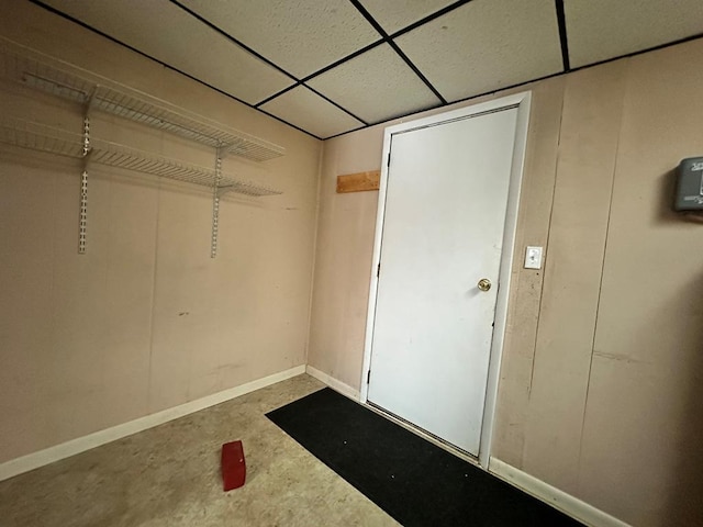 unfurnished bedroom with a closet and a drop ceiling