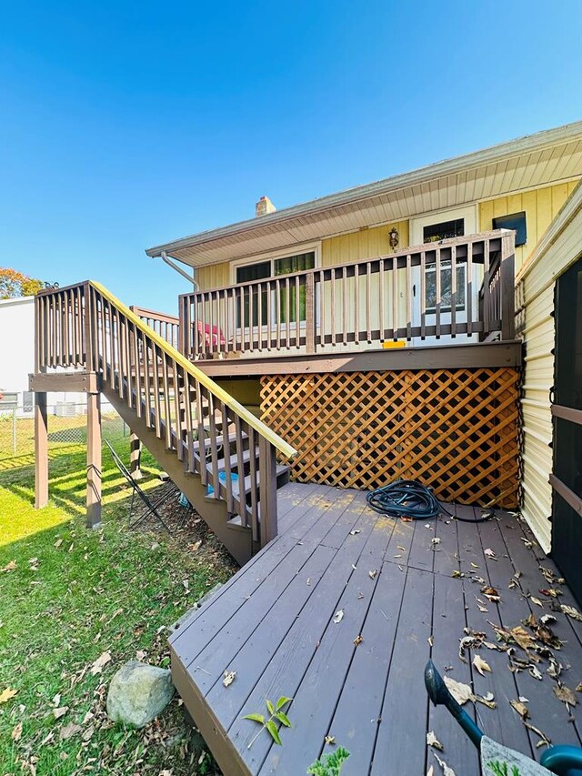 wooden terrace featuring a yard