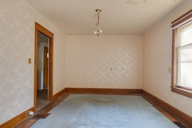 unfurnished room with hardwood / wood-style floors and ornamental molding