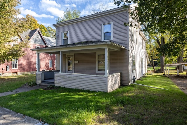 view of front of house with a front yard and covered porch