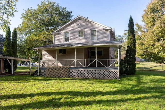 rear view of house with a porch and a yard