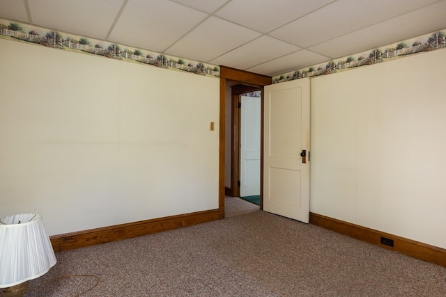 empty room with carpet and a drop ceiling