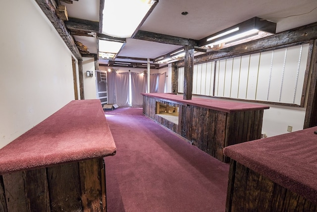 interior space featuring carpet floors and indoor bar