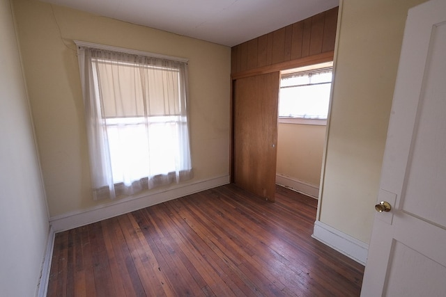 spare room with dark wood-type flooring