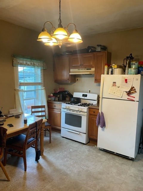 kitchen featuring hanging light fixtures, an inviting chandelier, and white appliances