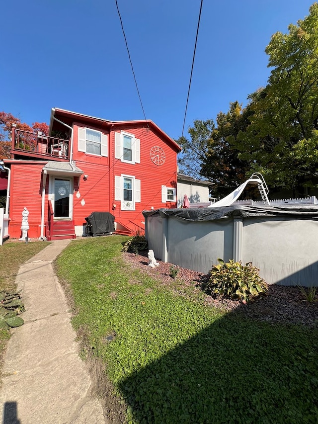 view of side of home featuring a yard