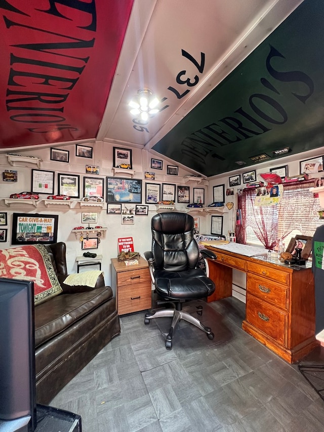 office with lofted ceiling with beams and built in desk