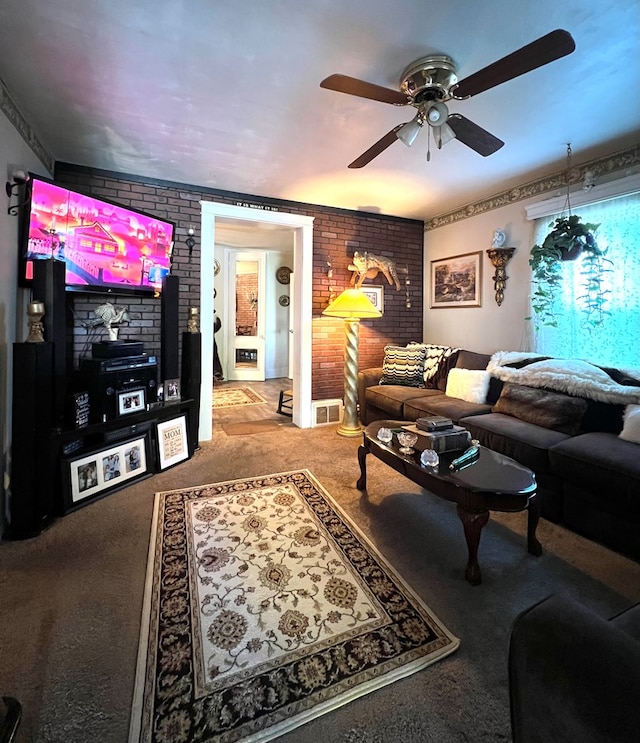 carpeted living room with brick wall and ceiling fan