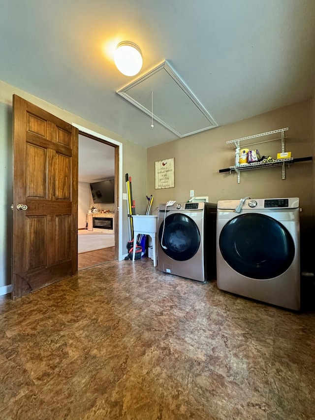 laundry area with washing machine and clothes dryer