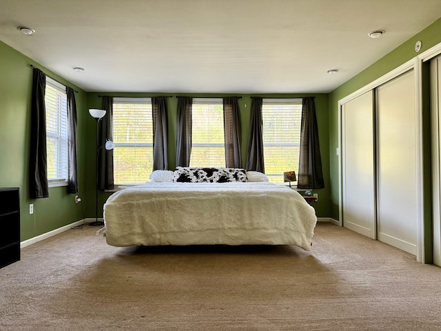 carpeted bedroom with multiple windows