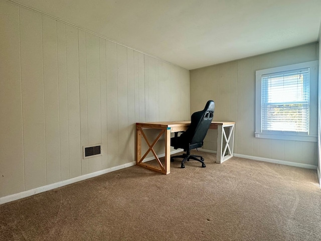 carpeted office with wood walls