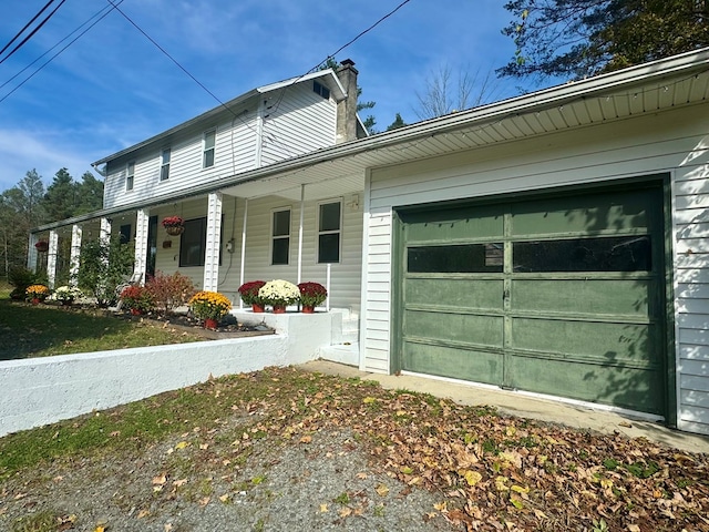 view of side of home with a porch and a garage