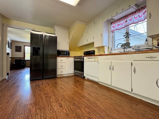 kitchen with dark hardwood / wood-style floors, white cabinetry, and stainless steel appliances