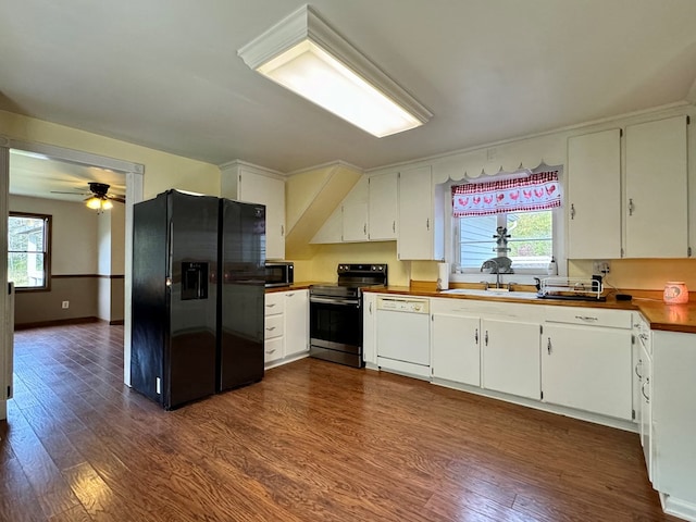 kitchen featuring white cabinets, dark hardwood / wood-style floors, a healthy amount of sunlight, and stainless steel appliances