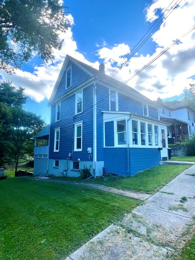 view of home's exterior with a yard