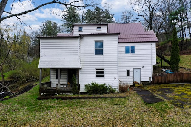 rear view of house featuring a yard