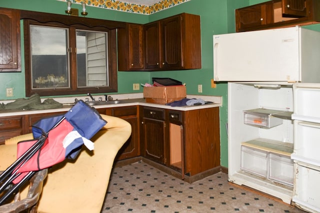 kitchen featuring white refrigerator and sink