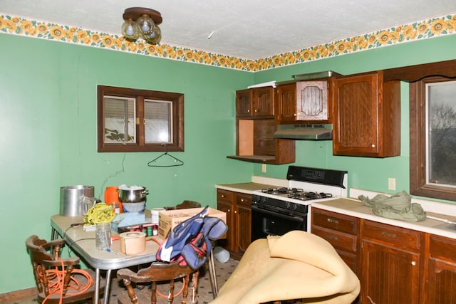 kitchen with a textured ceiling and gas range gas stove