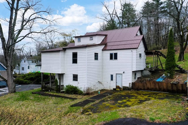 back of property featuring a lawn