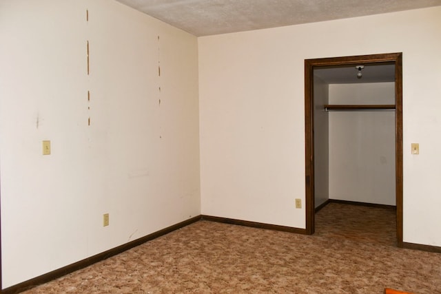 unfurnished bedroom with a closet, carpet floors, and a textured ceiling