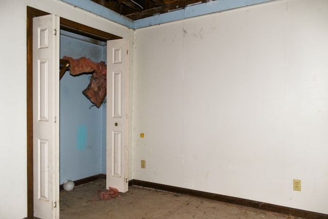 unfurnished bedroom with concrete flooring