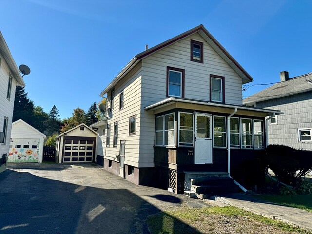 front facade with a garage and an outdoor structure