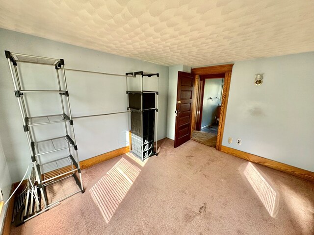 unfurnished bedroom featuring light carpet