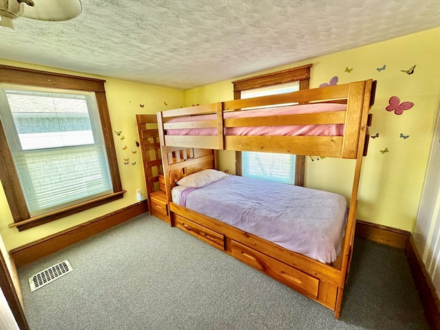 carpeted bedroom featuring a textured ceiling