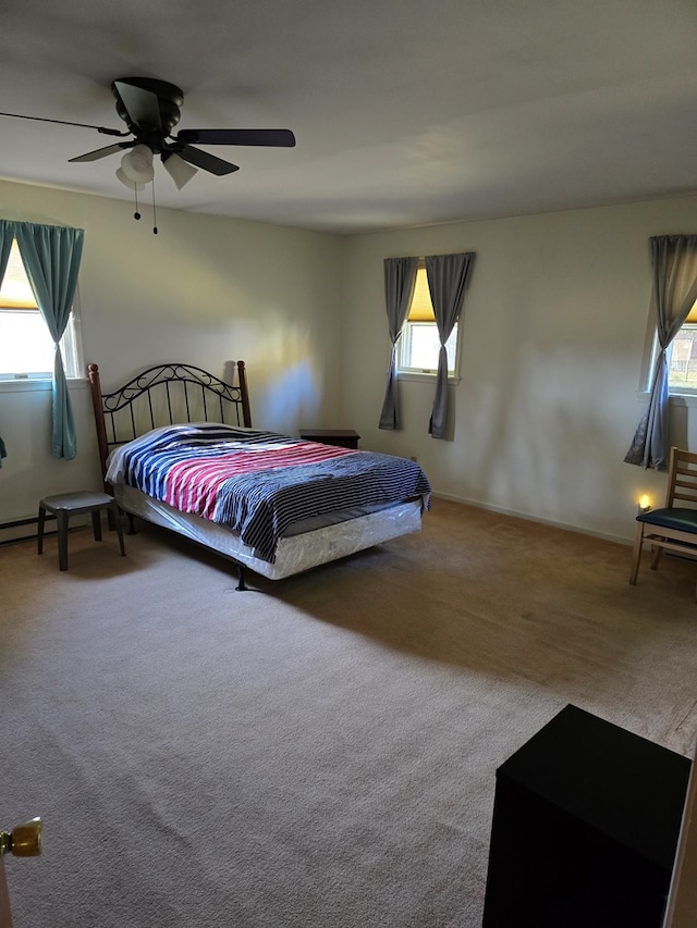 bedroom with carpet, ceiling fan, and multiple windows