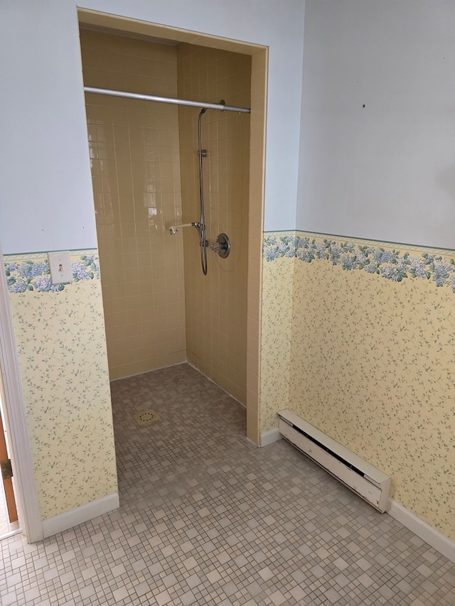 bathroom featuring a tile shower and a baseboard radiator